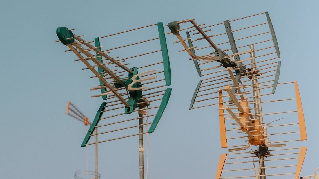 Rooftop television and radio antennas against the sky