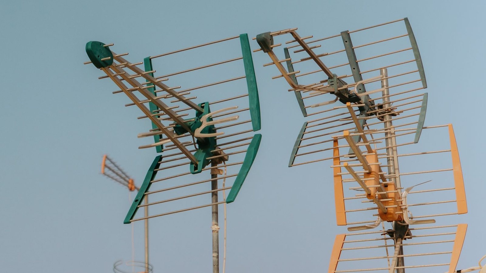 Rooftop television and radio antennas against the sky