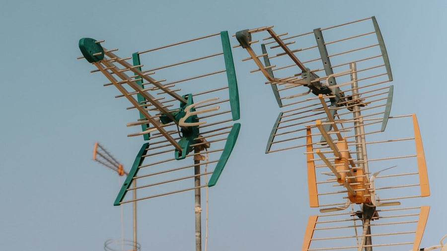 Rooftop television and radio antennas against the sky